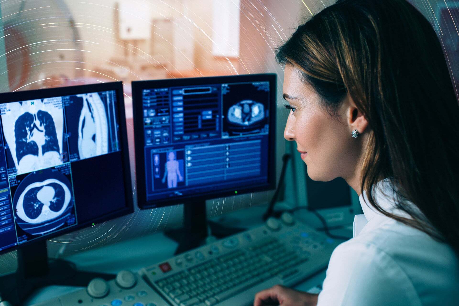 Radiologist reviewing CT scans on a multi-monitor workstation