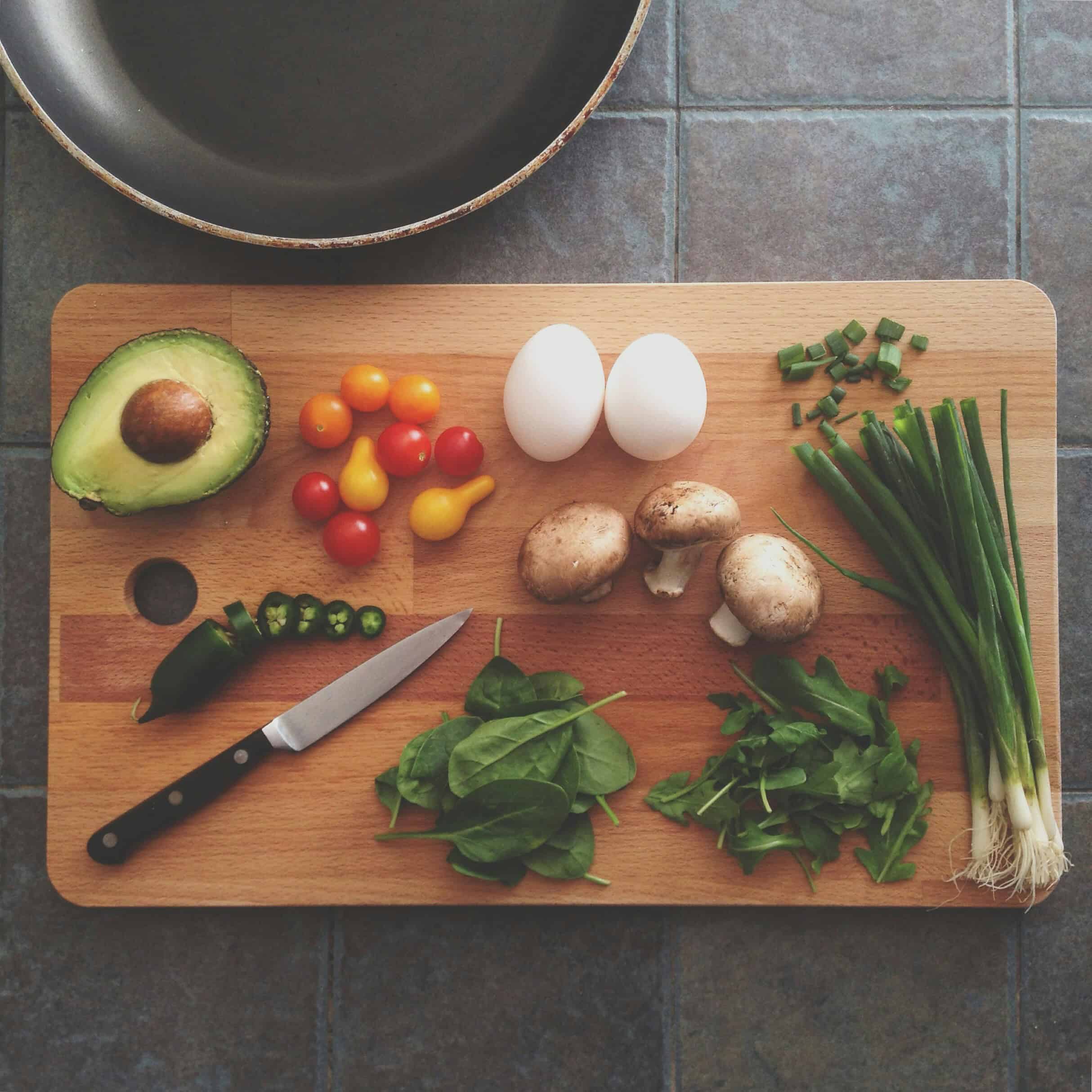Hands preparing fresh food in a kitchen