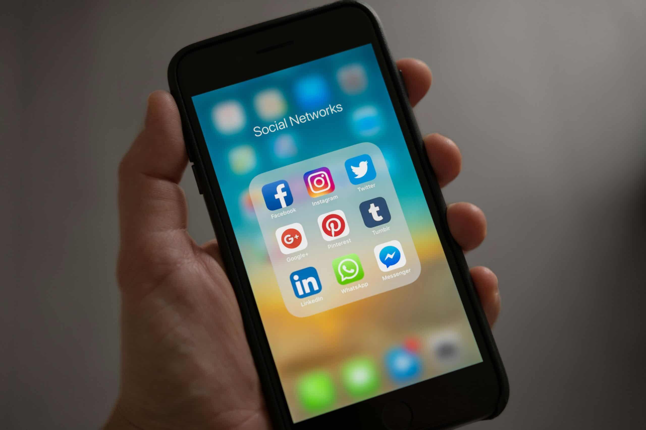 iPhone showing social media apps on home screen such as Facebook, Instagram and LinkedIn.