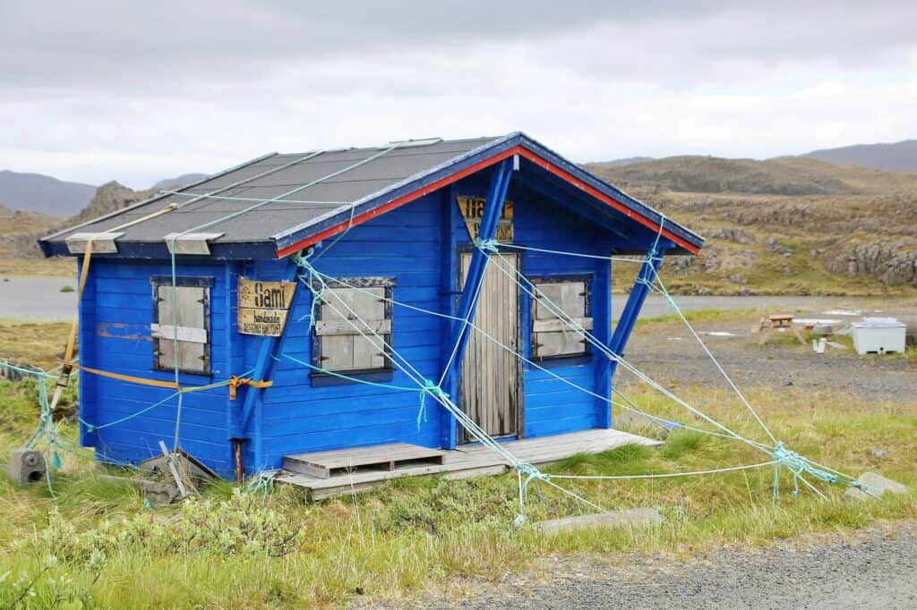 image of an old hut, held by ropes