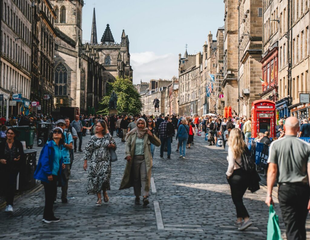 photo of Edinburgh Royal Mile during a day with many people walking by